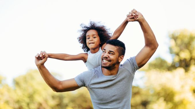 father-carrying-daughter - Father's Day Tradition