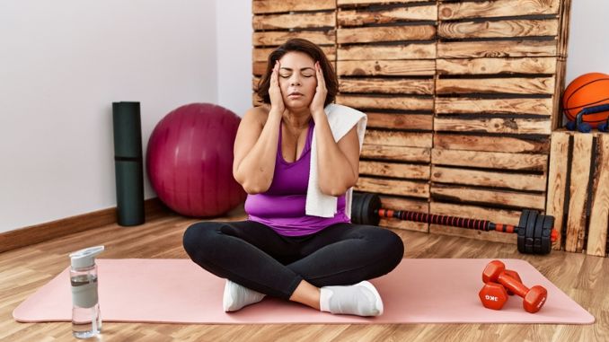 woman sitting on training mat