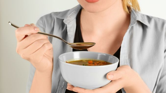 woman eating lentil soup