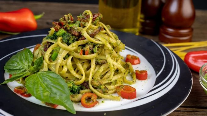 pasta-with-green-vegetable-on-white-and-black-ceramic-plate